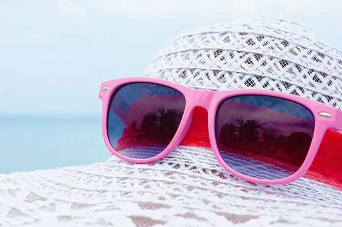 Pink sunglasses on a white hat