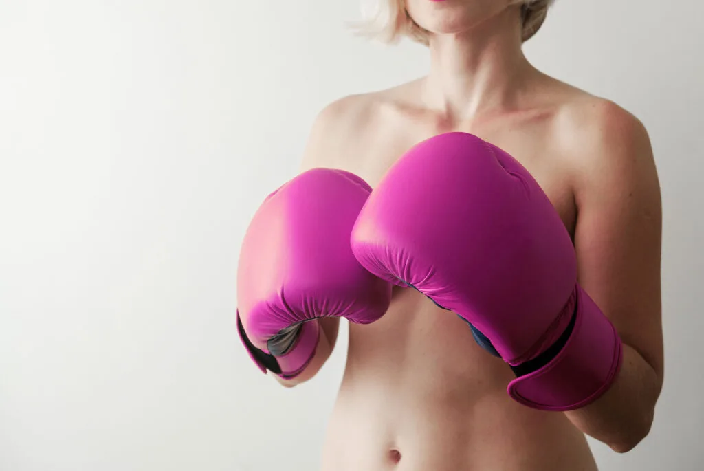 Woman wearing pink boxing gloves
