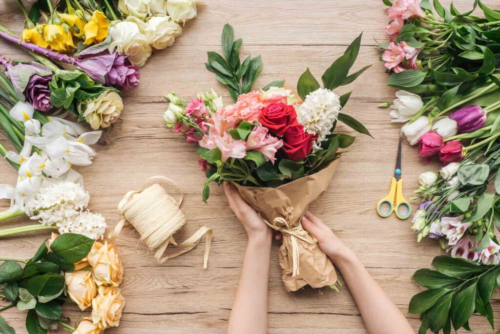 Florist making a bouquet of different flower colors