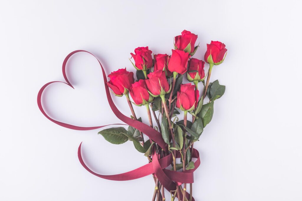 Red roses bouquet and a heart ribbon