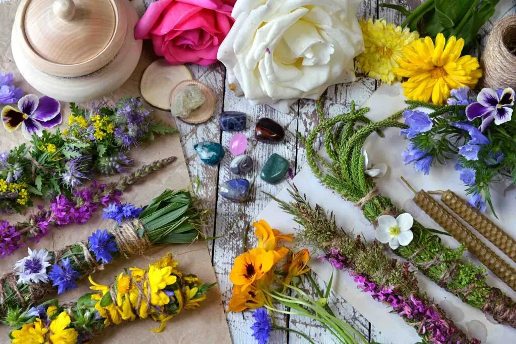 Witchery scrolls, herbs, flowers, and candles