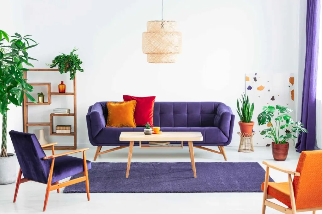 Indigo couch with red and orange pillows