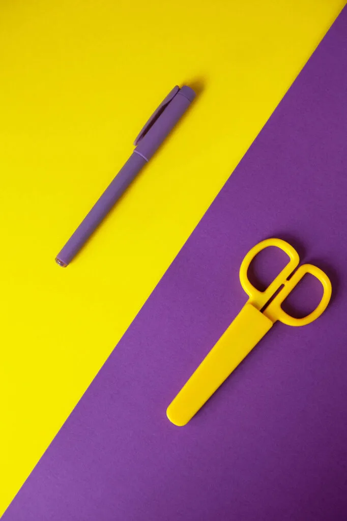 Yellow and purple pen and scissors