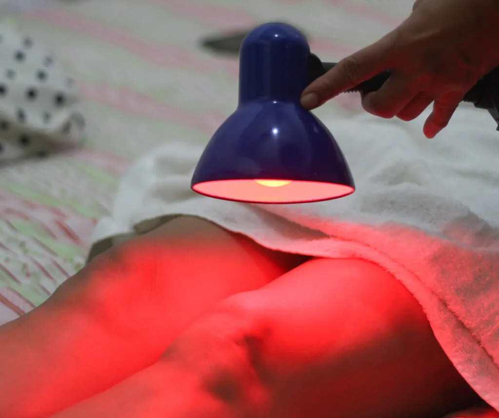 Woman doing color therapy with red light
