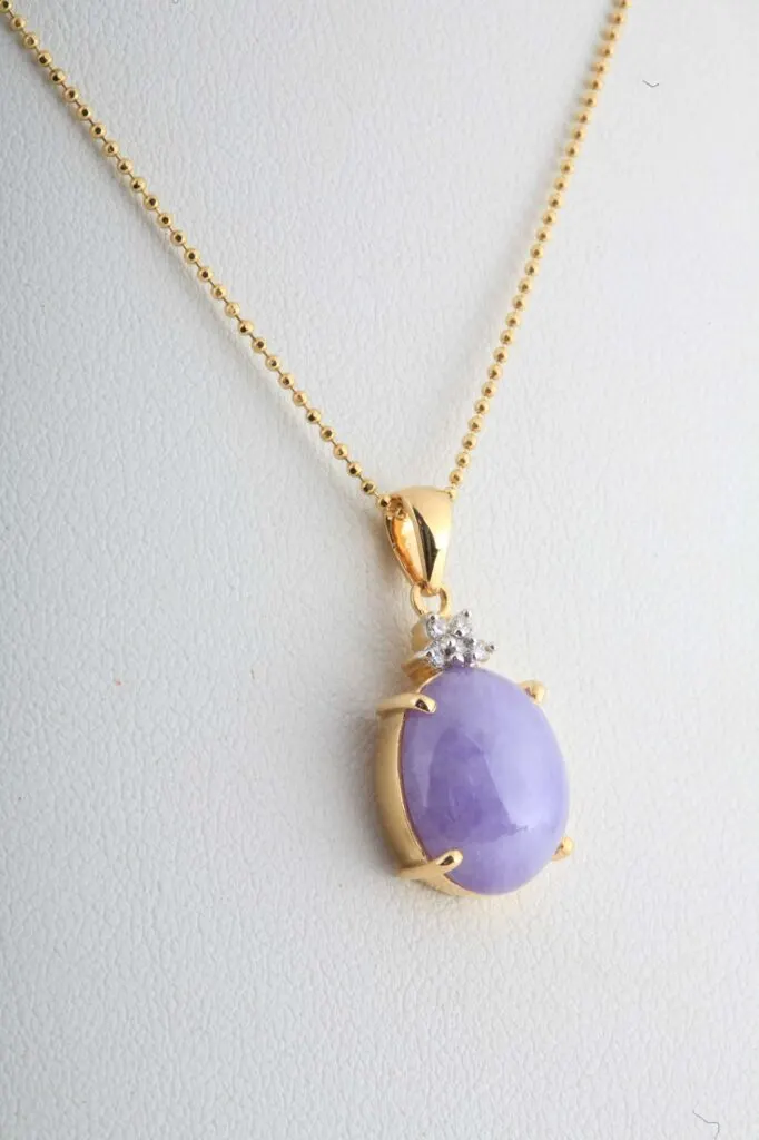 Purple jade pendant in a golden necklace