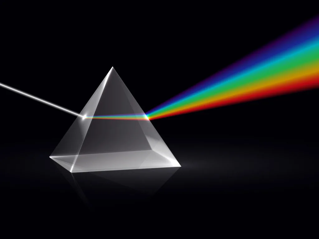 White light shining on a light prism and turning into the rainbow