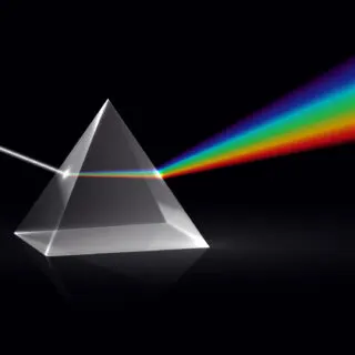 White light shining on a light prism and turning into the rainbow