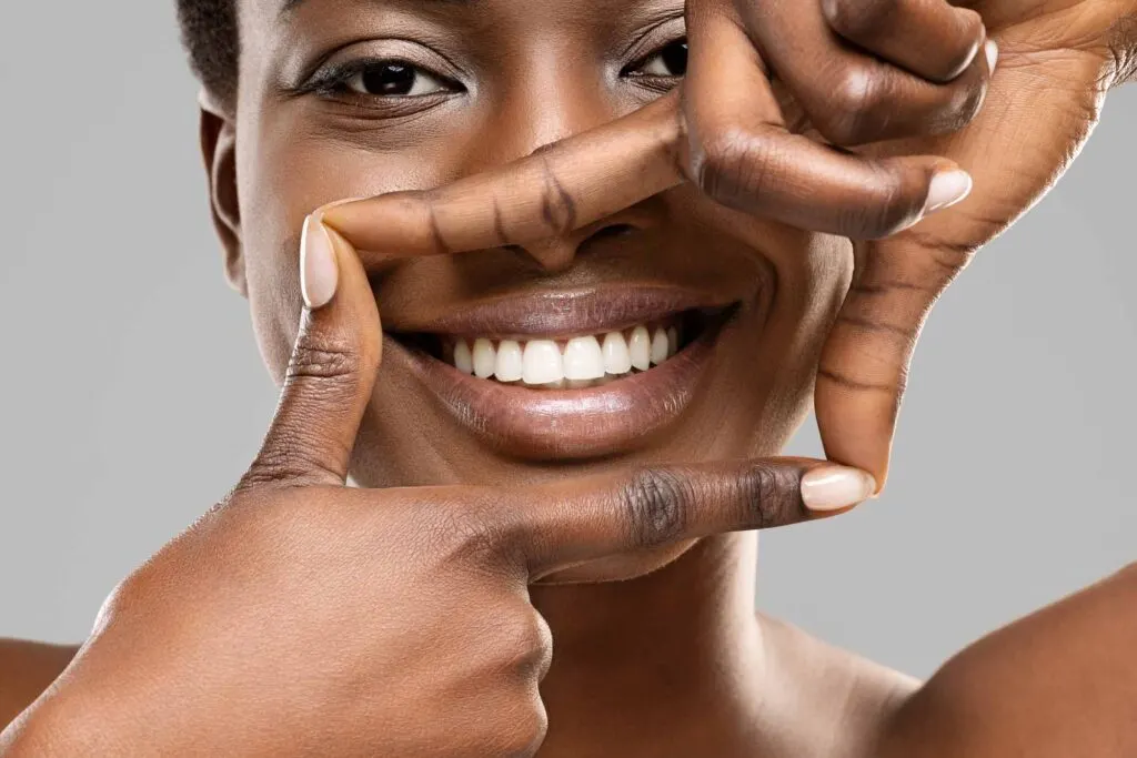 Black woman smiling and showing her white teeth