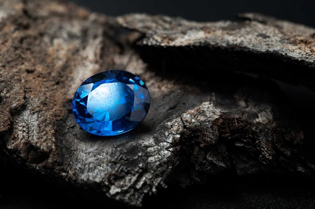 Blue sapphire gemstone on rock