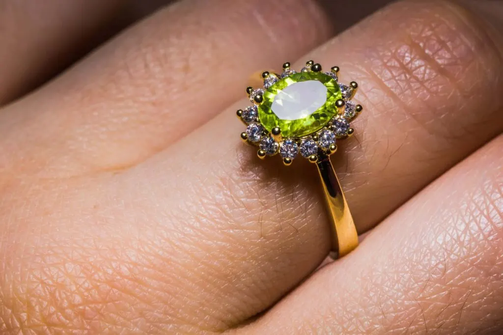 Green peridot ring on female's hand
