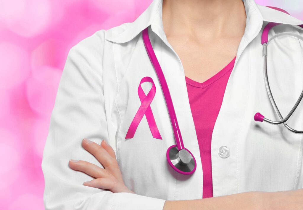 Female doctor with magenta or pink ribbon on chest