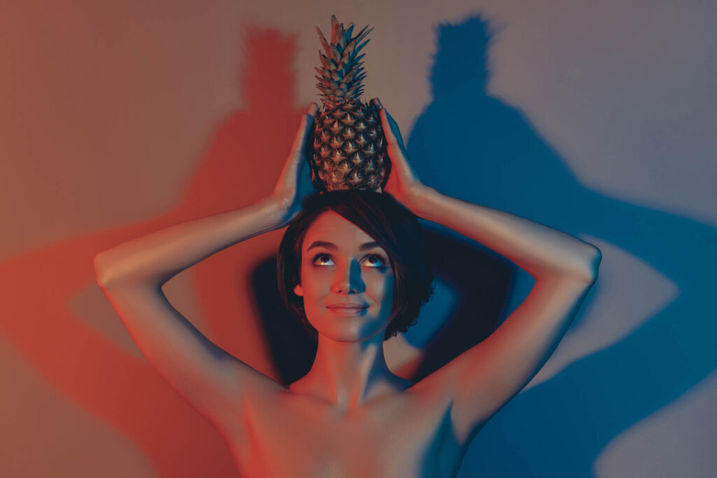 Woman holding pineapple on her head