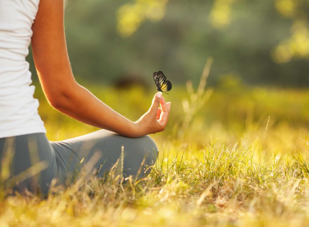 Young woman practicing meditation in nature