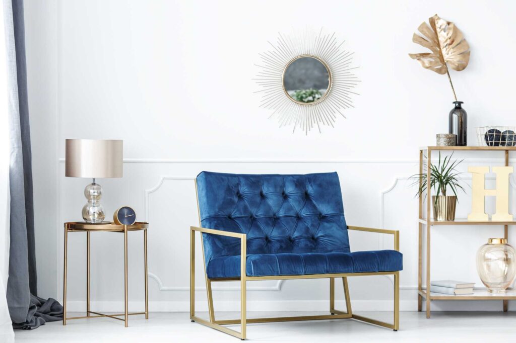 Light living room with blue chair and metallic gold details