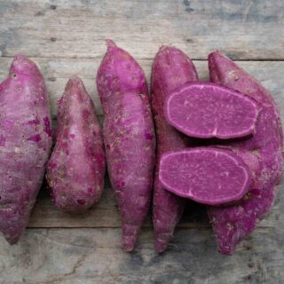 Purple sweet potatoes on wooden splat
