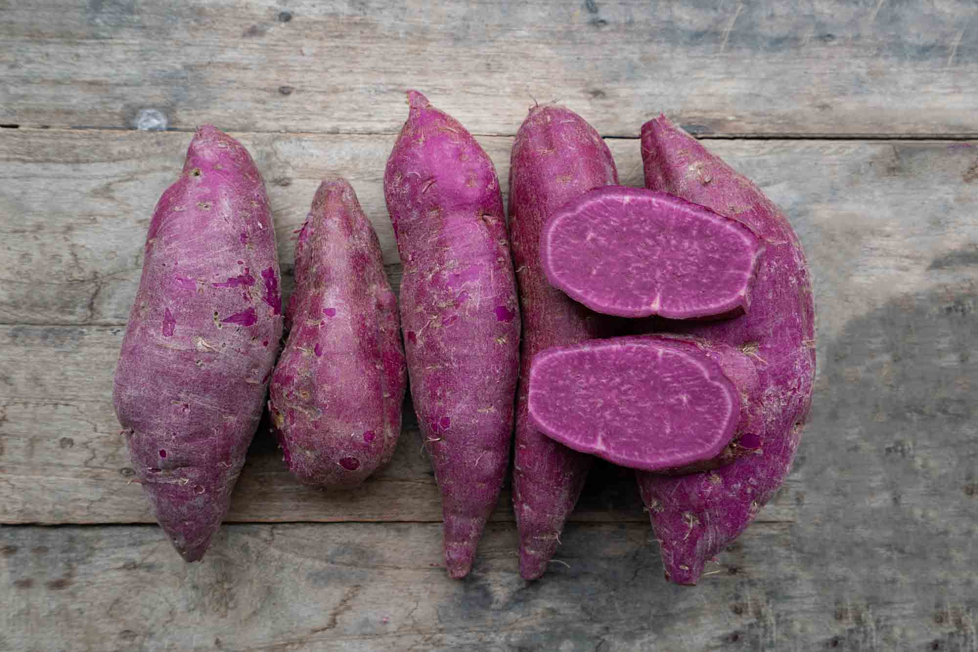 Purple sweet potatoes on wooden splat