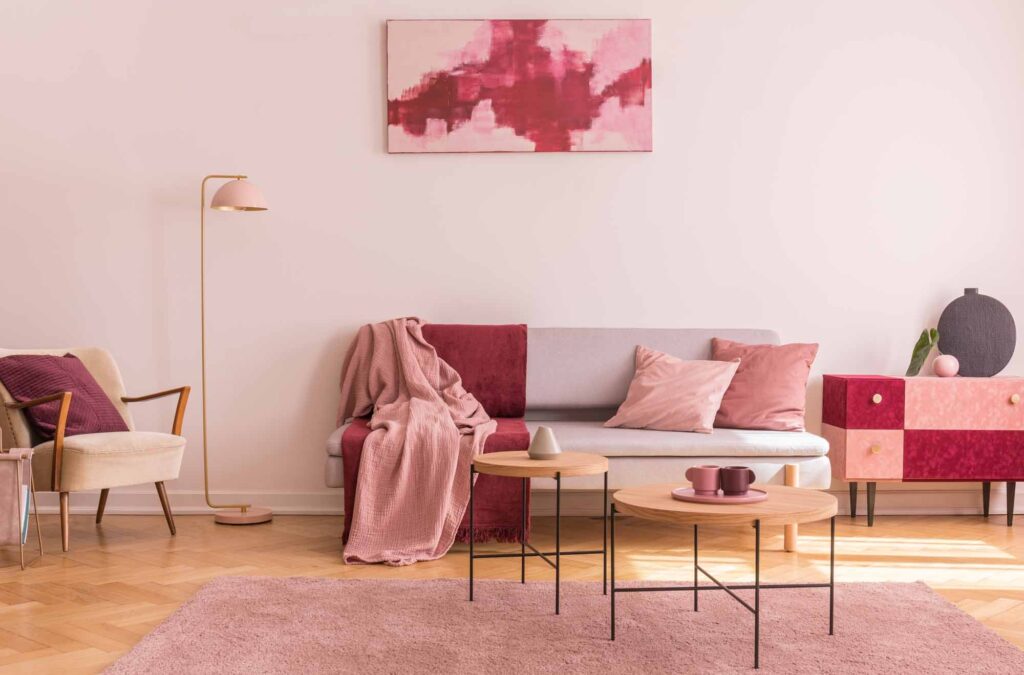 Pink room with red and pink pillows on the couch