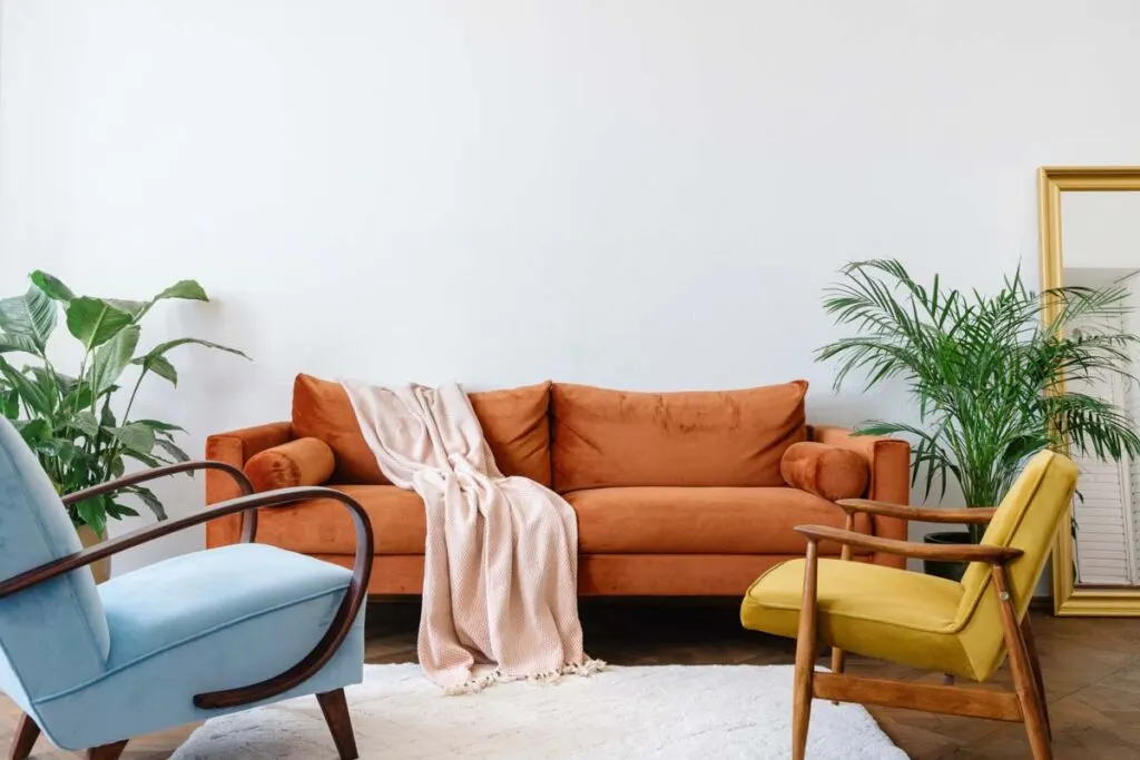 Orange couch and yellow chair in living room