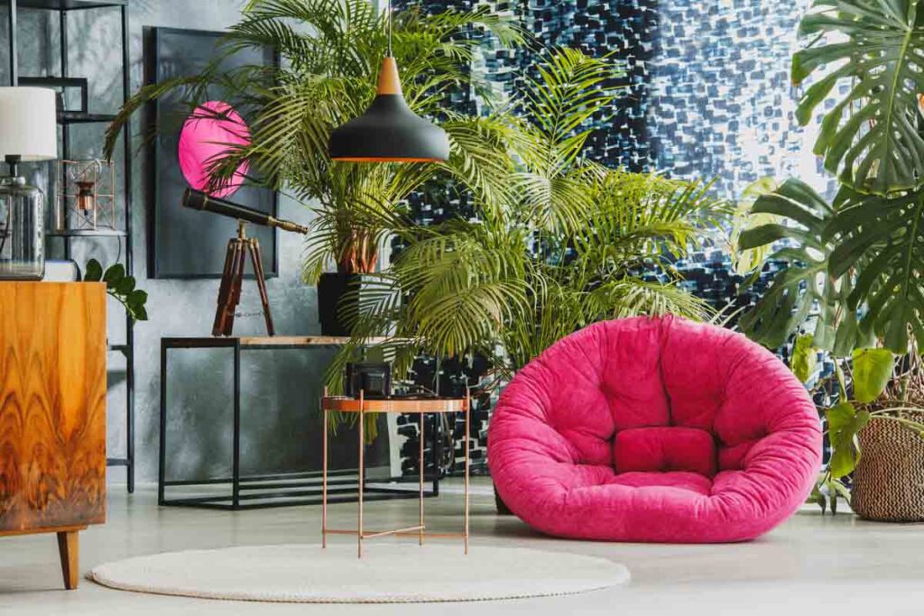 Spacious living room with pink plush armchair and black accents