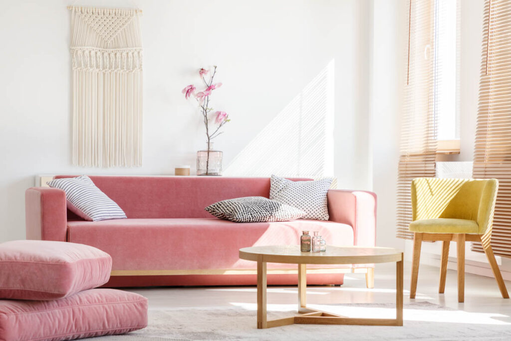 Pink couch and yellow chair in living room