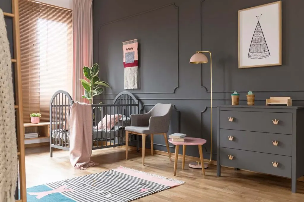 Gray wall and pink accents in baby's bedroom