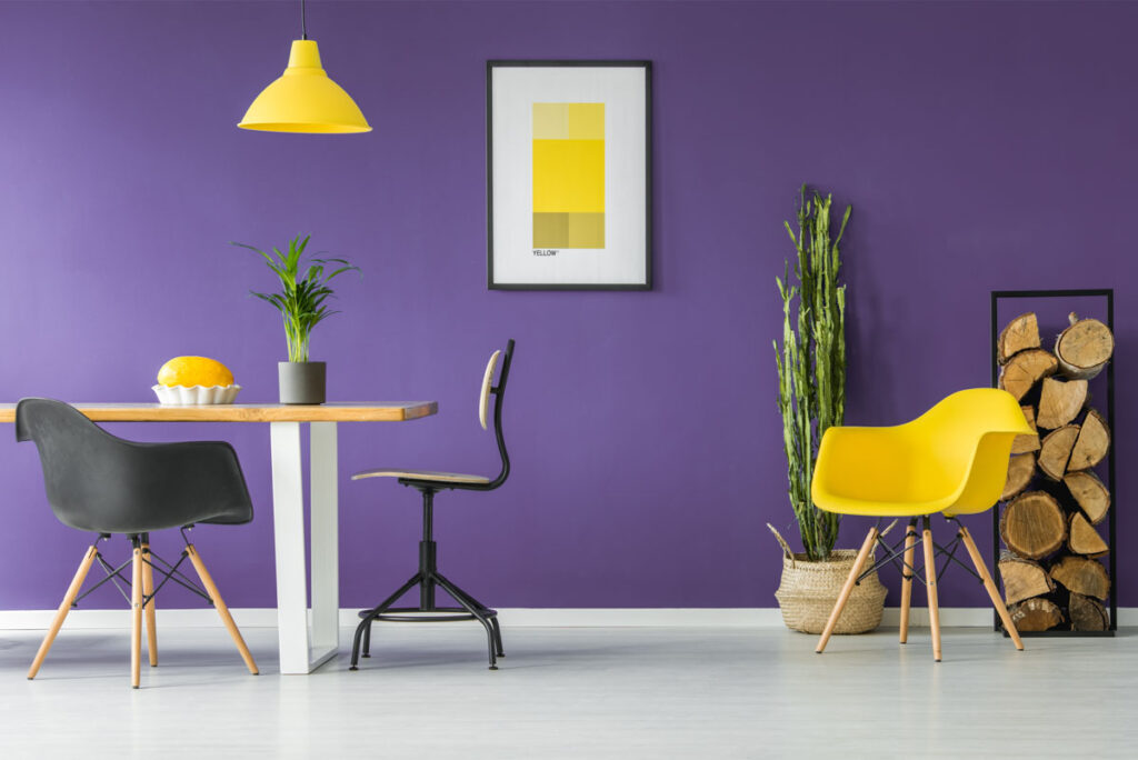 Purple wall and yellow chair in dining room
