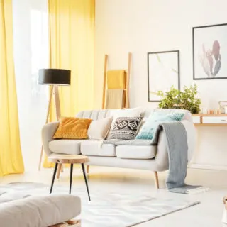 White living room with yellow curtains