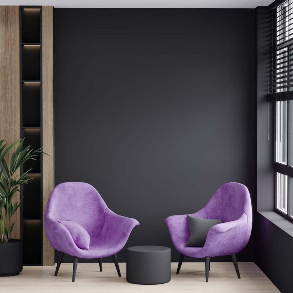black wall and purple armchairs in living room