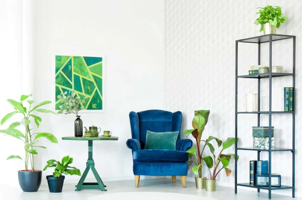 Royal blue chair near lime green wall art in airy living room