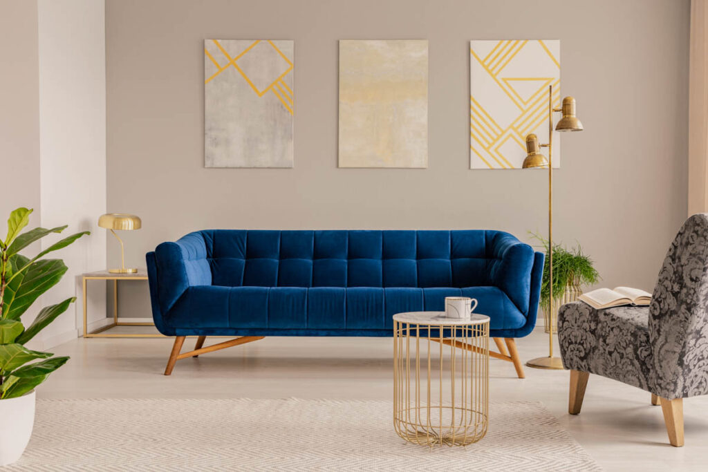 Royal blue couch in front of taupe wall in a living room