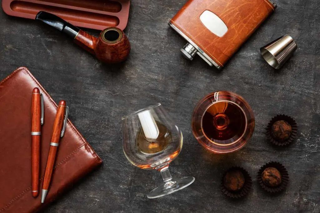 Glass of cognac and brown accessories