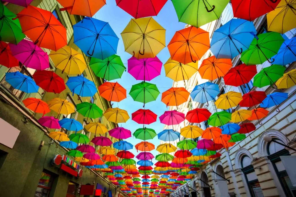 Colorful umbrellas hanging out above a street